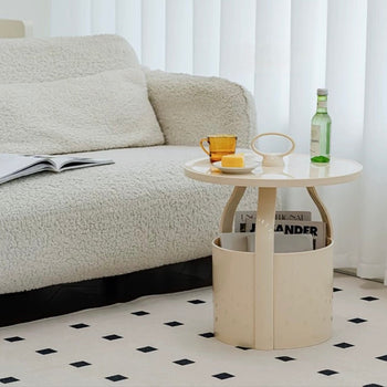 Round storage side table with handlein  includes magazine rack.