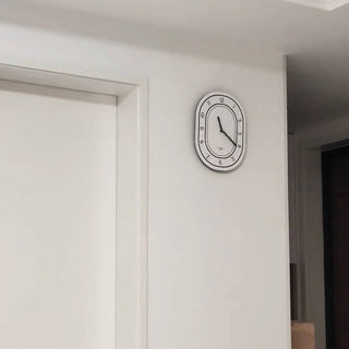 Oval-shaped acrylic white wall clock