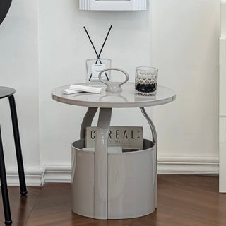 Round storage side table with handlein  includes magazine rack.