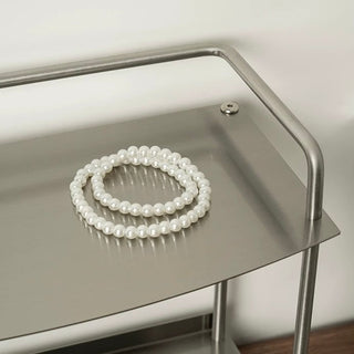 Stainless steel silver storage two-tier display rack for cosmetics and perfumes.
