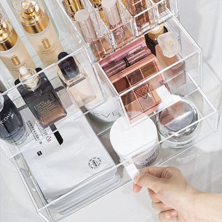 Square-shaped clear cosmetic boxin  for makeup storage.