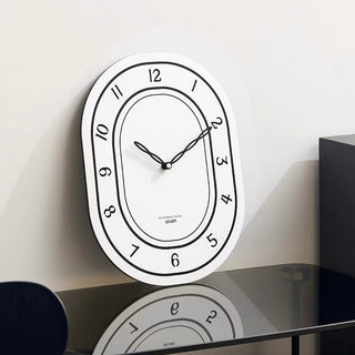 Oval-shaped acrylic white wall clock