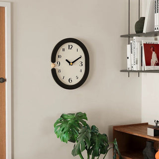 Oval-shaped monochrome modern art wall clock