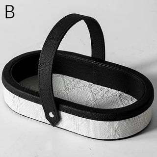 Oval-shaped leather jacquard tray with handlein .