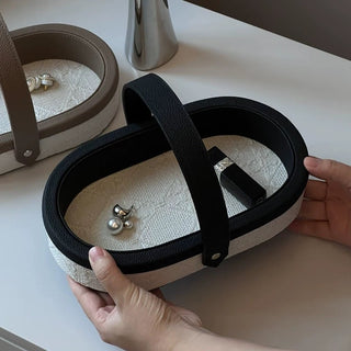 Oval-shaped leather jacquard tray with handlein .