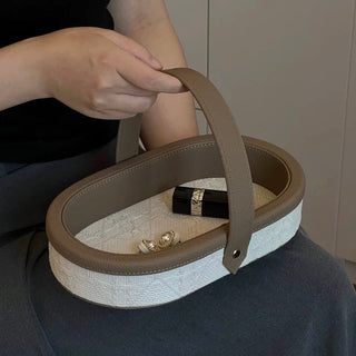 Oval-shaped leather jacquard tray with handlein .