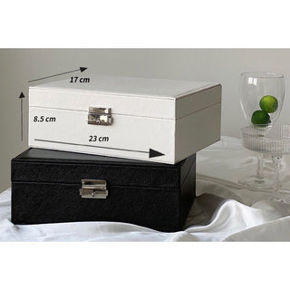 Two-tiered lockable simple jewelry boxin  storage.
