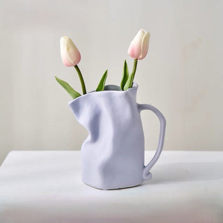 Ceramic flower vase with handlein .