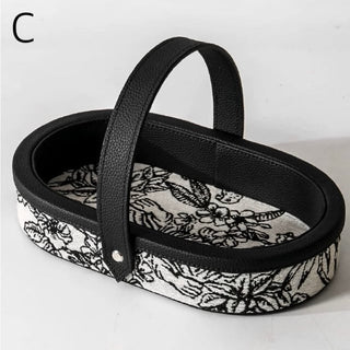 Oval-shaped leather jacquard tray with handlein .