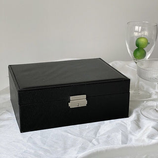 Two-tiered lockable simple jewelry boxin  storage.