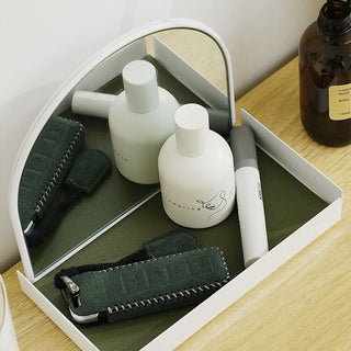 Arched storage tray with mirrorin  for storing small items.