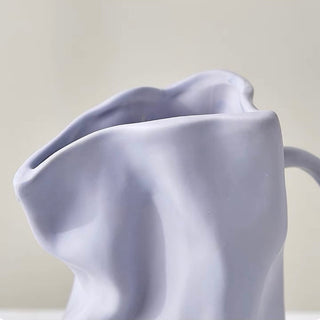 Ceramic flower vase with handlein .