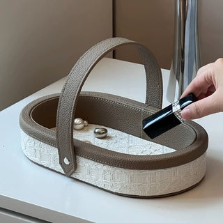 Oval-shaped leather jacquard tray with handlein .