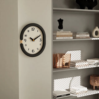 Oval-shaped monochrome modern art wall clock