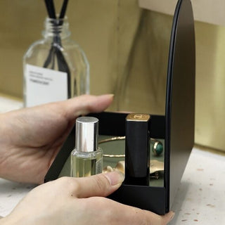 Arched storage tray with mirrorin  for storing small items.