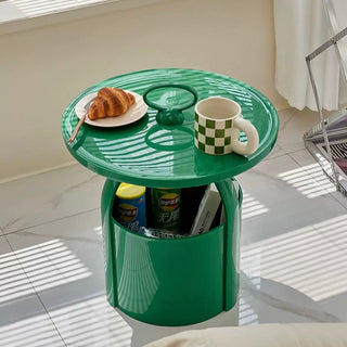 Round storage side table with handlein  includes magazine rack.