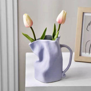 Ceramic flower vase with handlein .