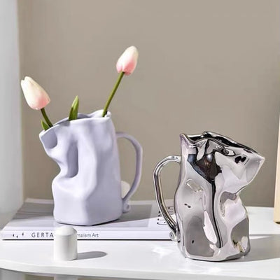 Ceramic flower vase with handlein .
