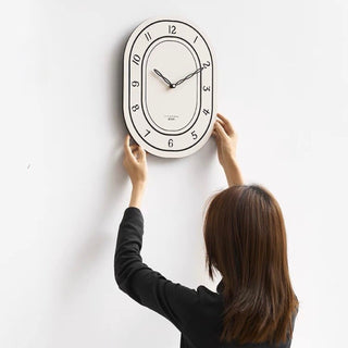 Oval-shaped acrylic white wall clock