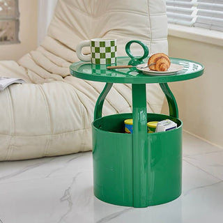 Round storage side table with handlein  includes magazine rack.