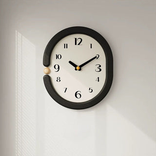 Oval-shaped monochrome modern art wall clock
