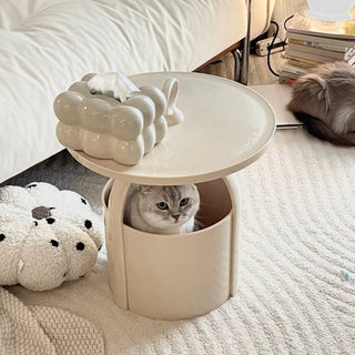 Round storage side table with handlein  includes magazine rack.