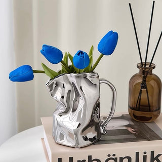 Ceramic flower vase with handlein .