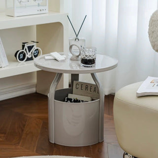 Round storage side table with handlein  includes magazine rack.