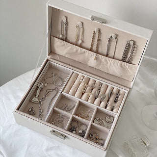 Two-tiered lockable simple jewelry boxin  storage.