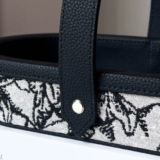 Oval-shaped leather jacquard tray with handlein .