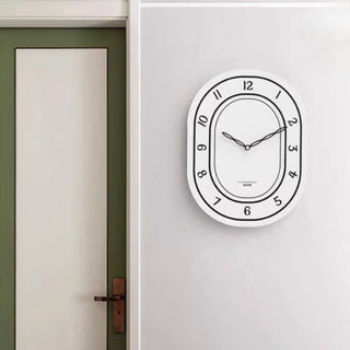 Oval-shaped acrylic white wall clock