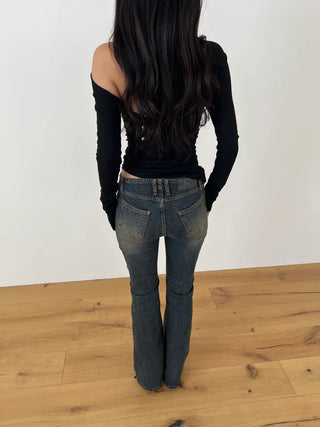Curved low-rise slim bootcut denim pants