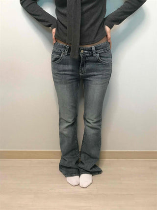Low-rise bootcut washed denim pants