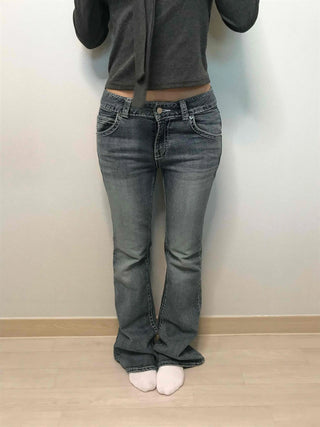 Low-rise bootcut washed denim pants