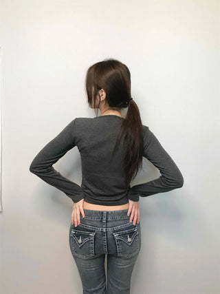 Low-rise bootcut washed denim pants