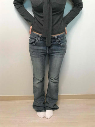 Low-rise bootcut washed denim pants