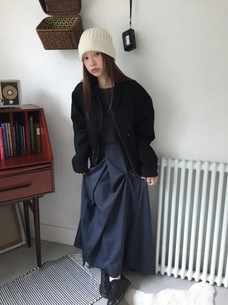 Black loose-fit jacket that accentuates a delicate silhouette