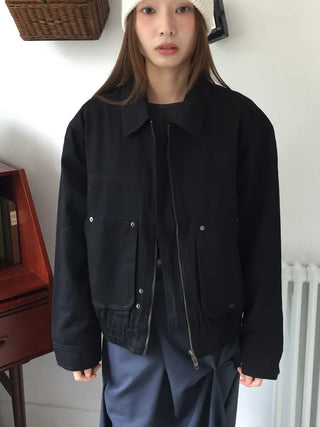 Black loose-fit jacket that accentuates a delicate silhouette