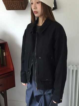 Black loose-fit jacket that accentuates a delicate silhouette