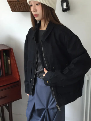 Black loose-fit jacket that accentuates a delicate silhouette
