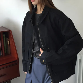 Black loose-fit jacket that accentuates a delicate silhouette