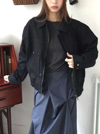 Black loose-fit jacket that accentuates a delicate silhouette