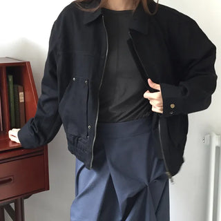 Black loose-fit jacket that accentuates a delicate silhouette