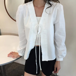 A delicate blouse completed with a single ribbon