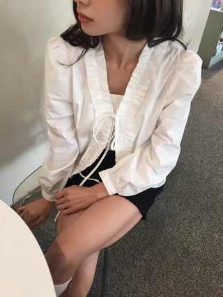 A delicate blouse completed with a single ribbon