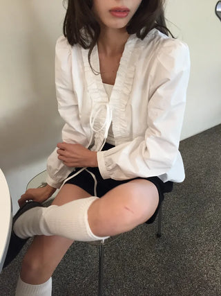 A delicate blouse completed with a single ribbon