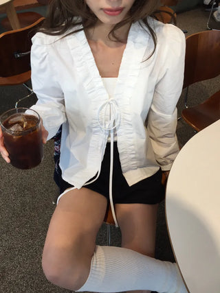 A delicate blouse completed with a single ribbon