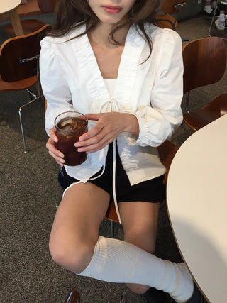 A delicate blouse completed with a single ribbon