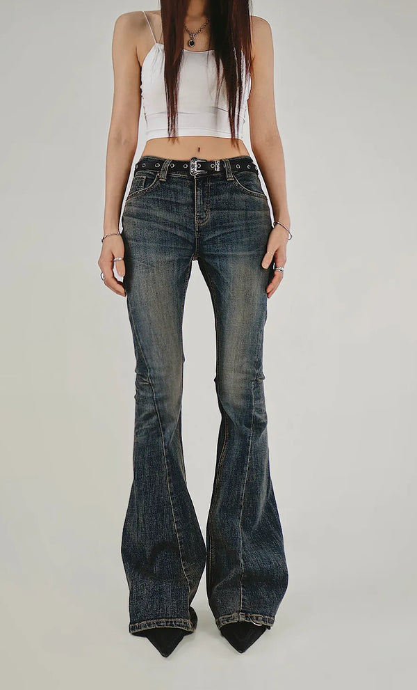 DOUBLE CURVED SHADOW BLUE WASHED DENIM BOOTCUT JEANS Denim bootcut jeans with double-edged curved cuts and shadow blue wash.