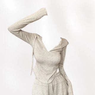 Semi zip up hooded training two piece set with slim fit top and wide loose fit training pants.